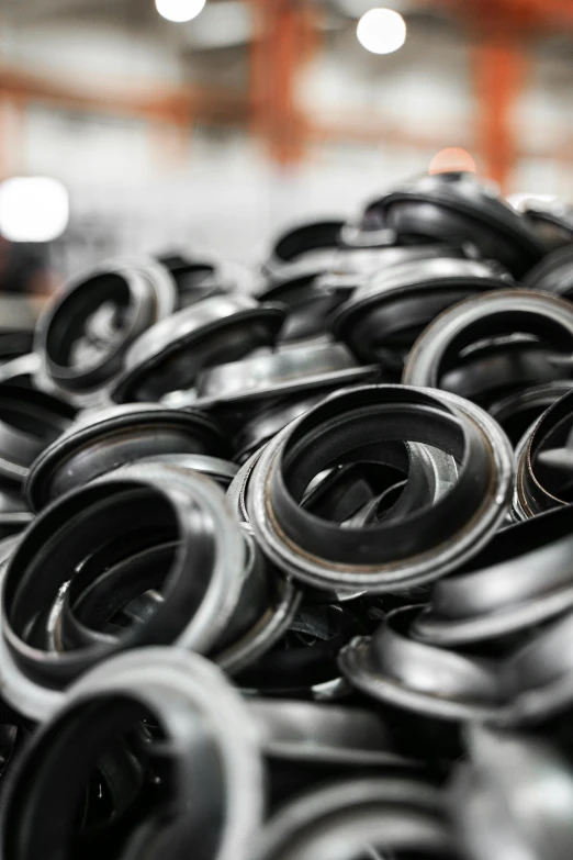 large pile of black plastic skateboard wheels in warehouse