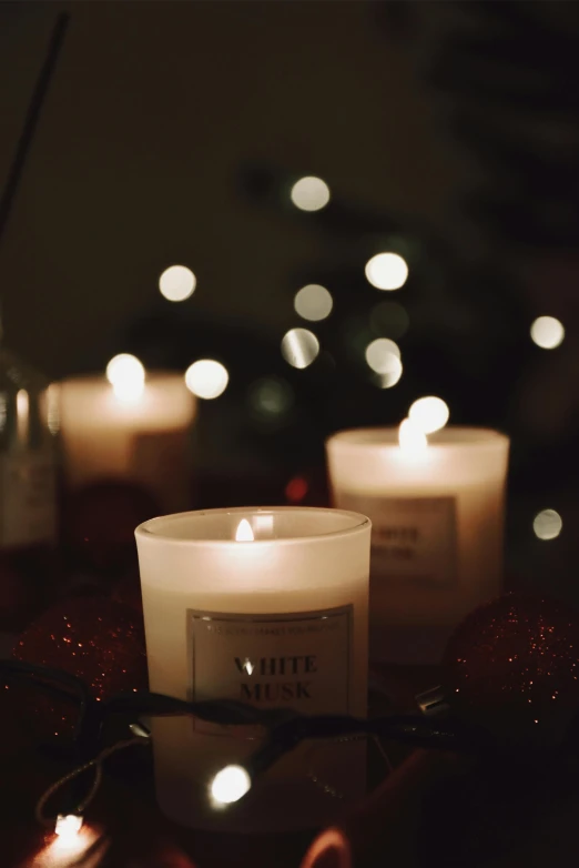 candles lit with white lights near a tree