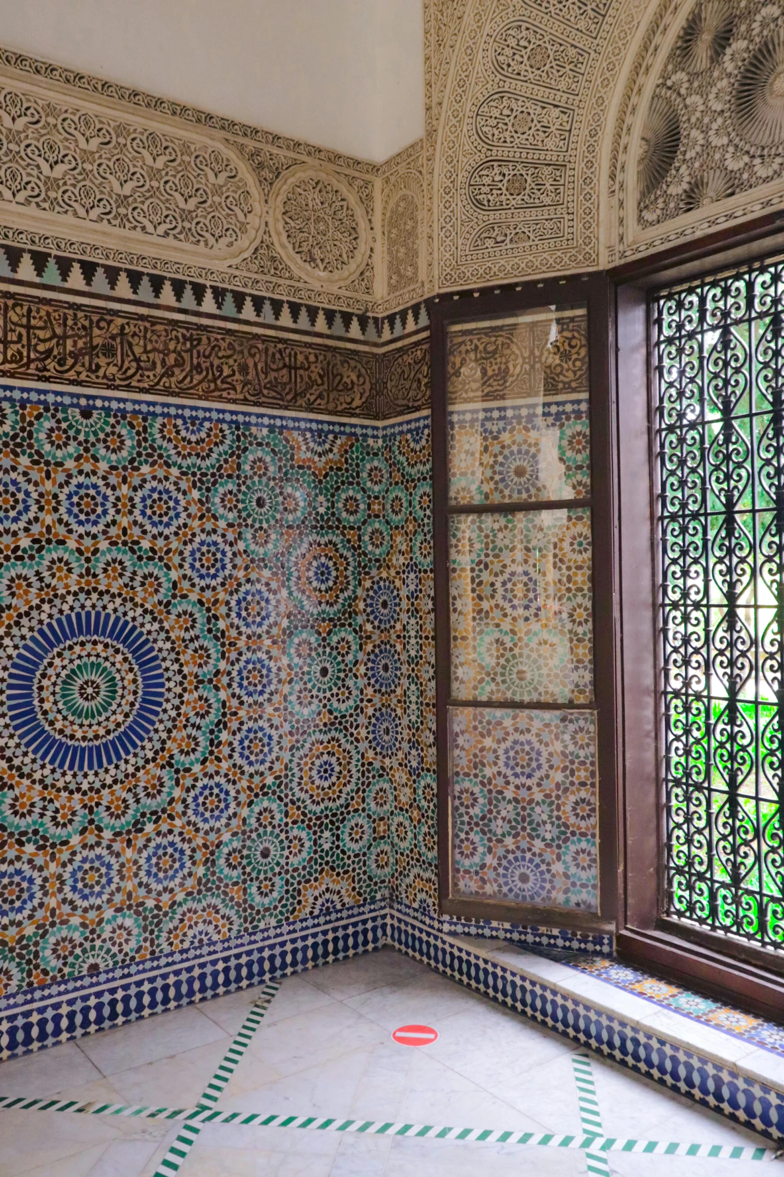 the walls are decorated with colorful tile and green windows