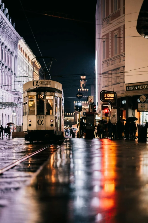 a tram on a city street at night