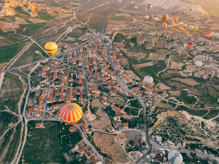 the  air balloons are in the air near a city