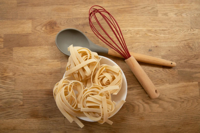 the pasta is being cooked in the bowl