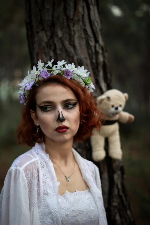 a woman in a headpiece has white flowers on her head