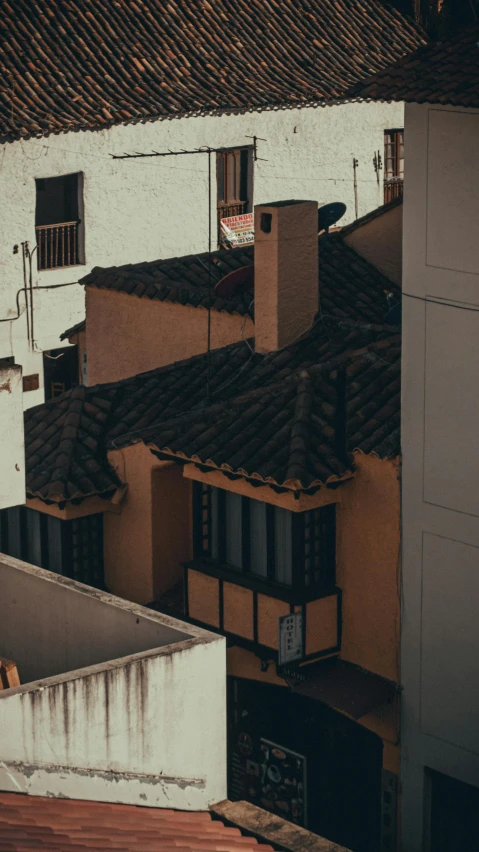 a few buildings next to each other with red tiled roofs