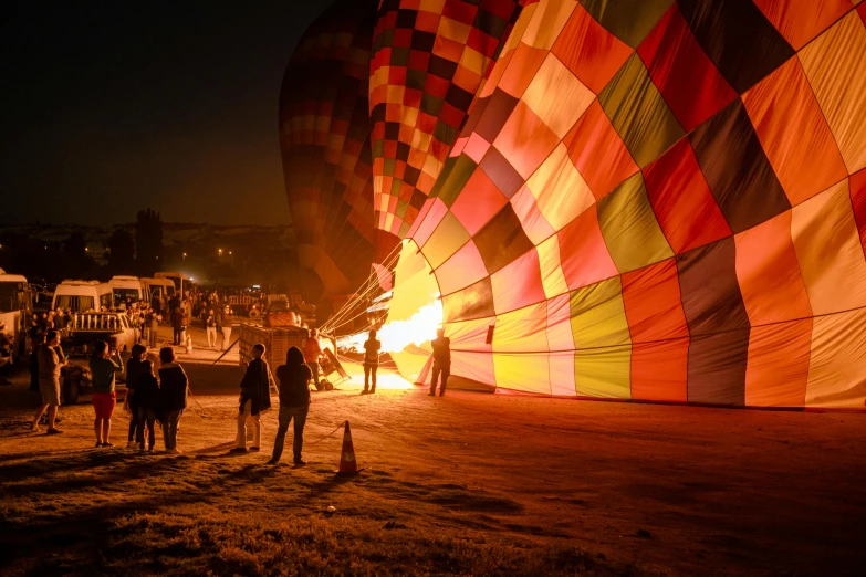 many people stand around an up  air balloon