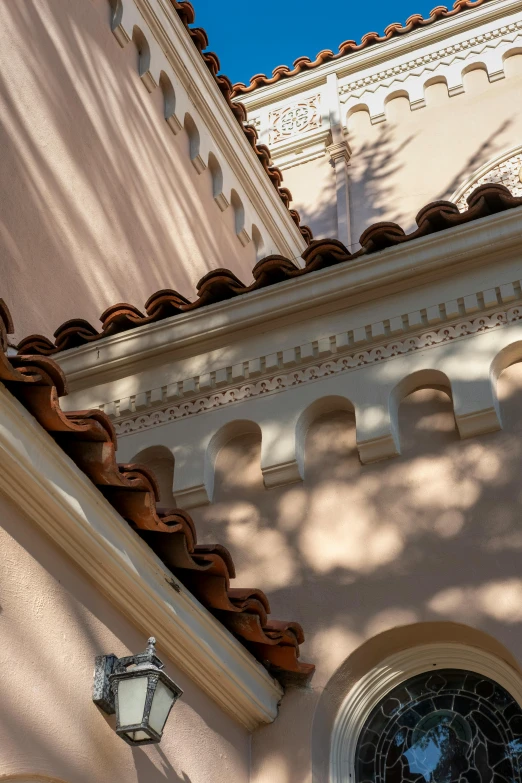 an elegant building with windows and a clock on the side