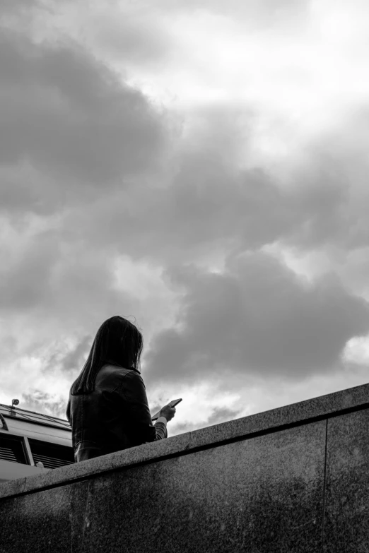 a black and white po of a person on a cell phone