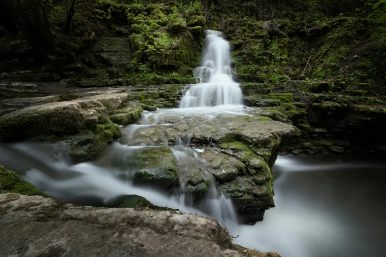 the water is pouring down the side of the waterfall