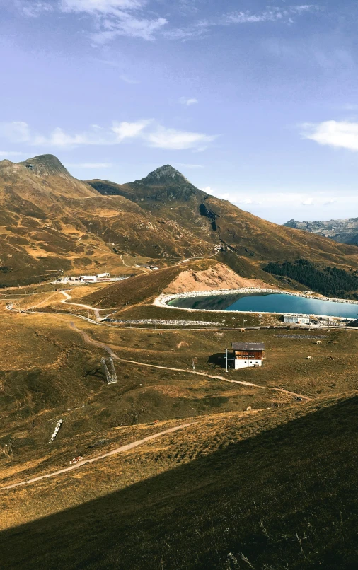 a large field and some mountains with houses