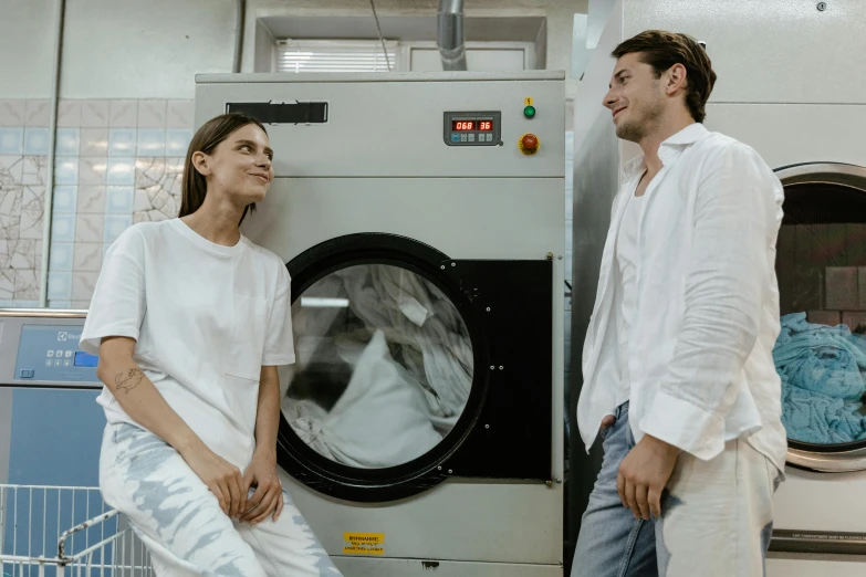 a man and woman are in a washing machine