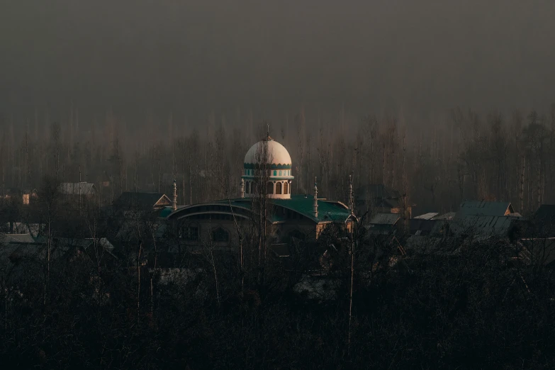 a domed green and white building is in the foreground, surrounded by fog