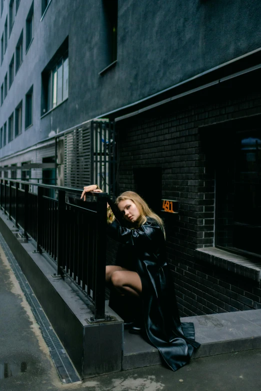 a woman standing on the steps in front of a tall building