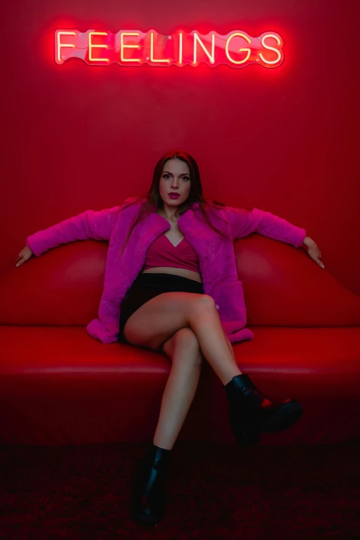 a girl in purple sitting on a red couch