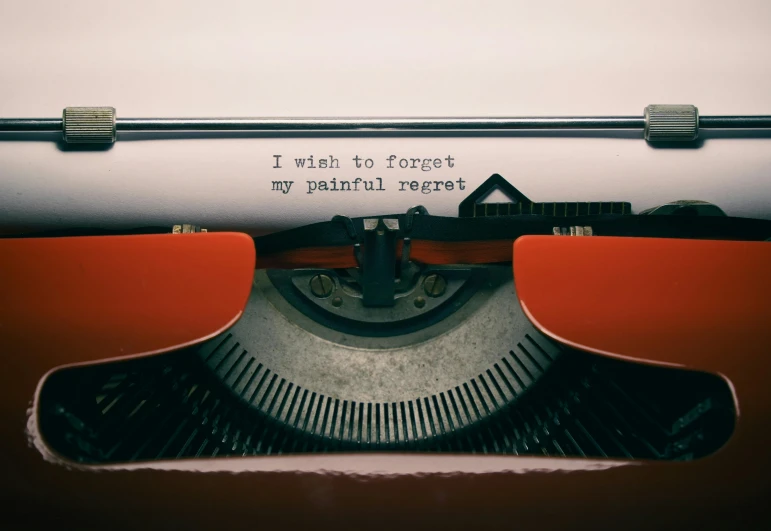 typewriter with paper on it with words written over it