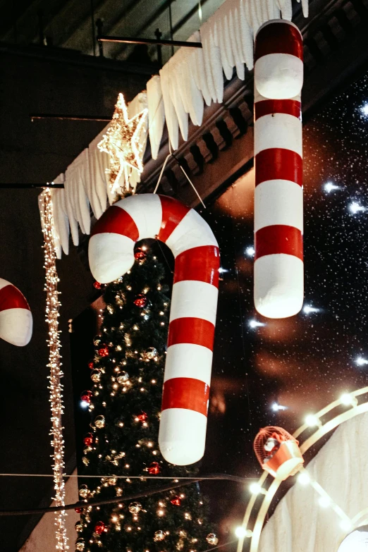 decorations and lights hang in the ceiling as christmas trees