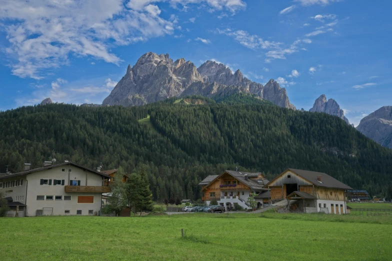 two cabins with mountains in the background