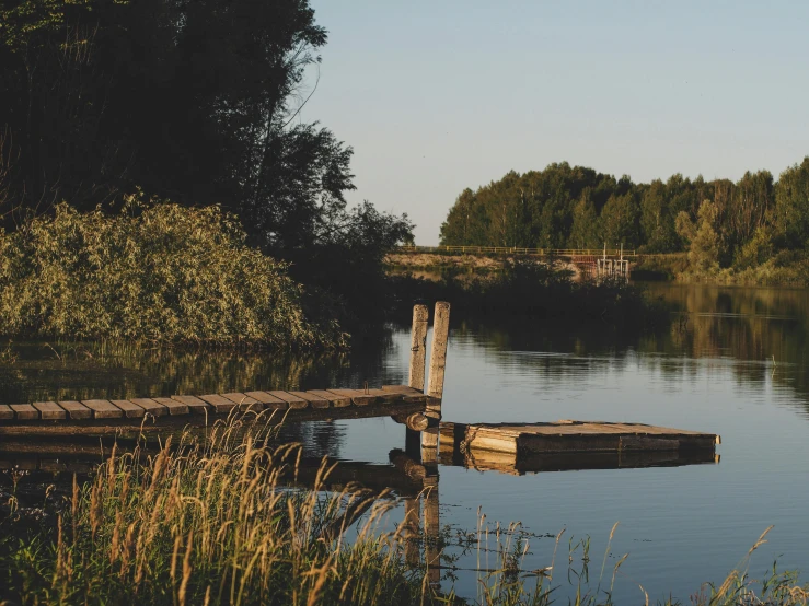 a small wooden pier sits in a body of water