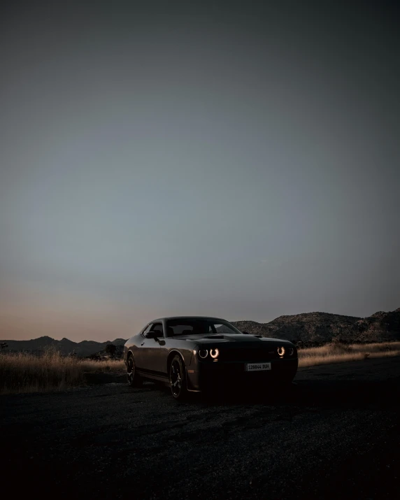 a car on the side of a road near the desert