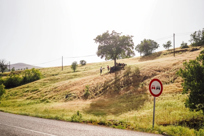 a red and white sign sitting on the side of a road