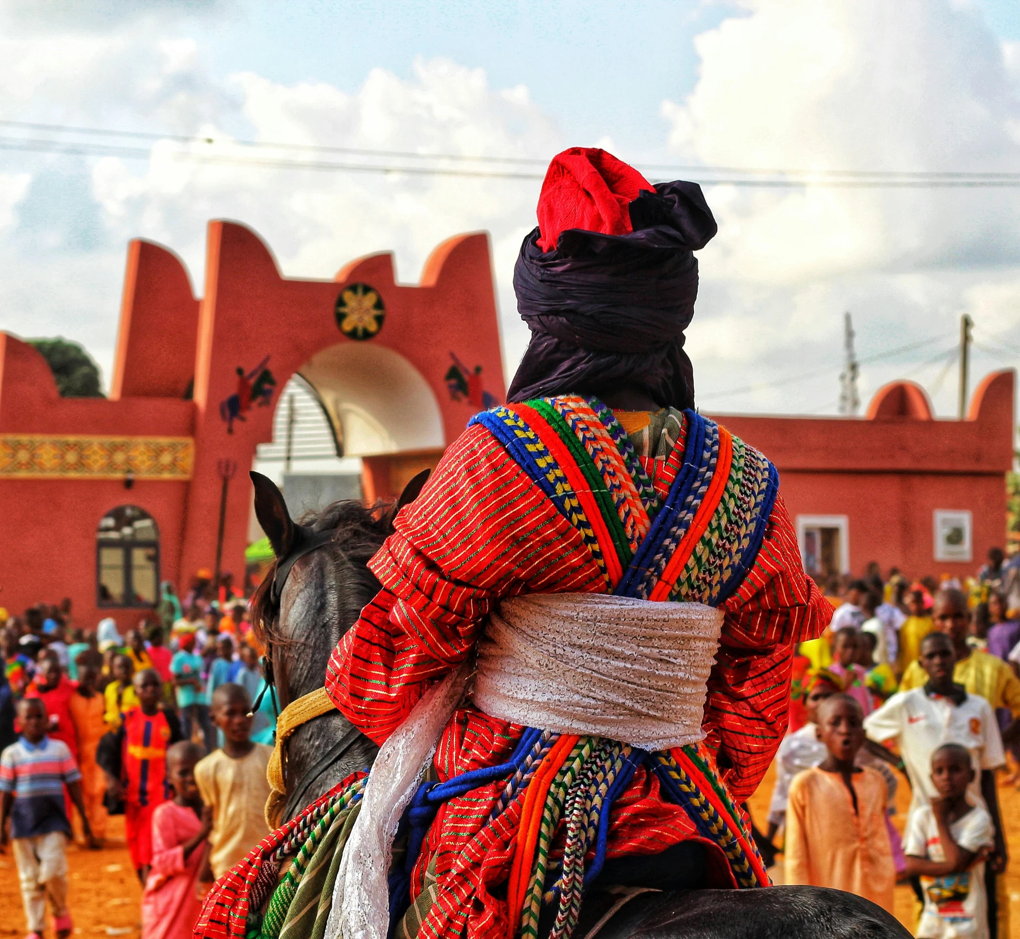 a woman is riding a horse in the middle of a crowded area