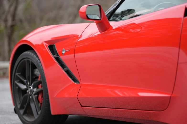 close up of a red sports car on a road