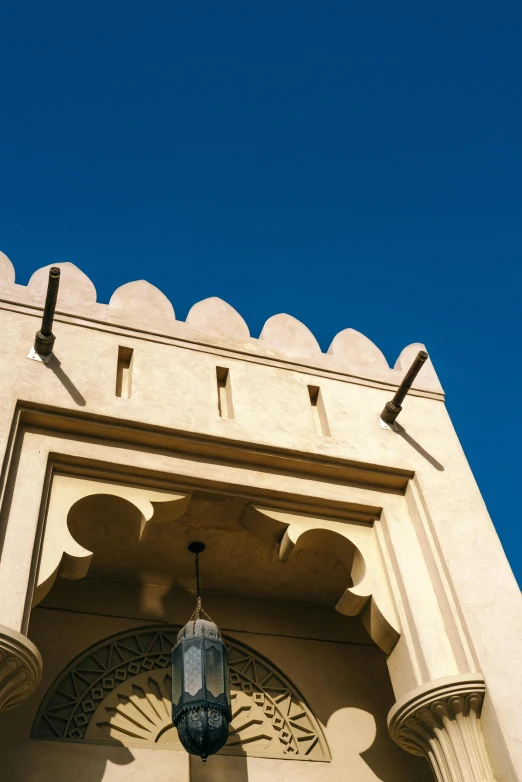 an old archway with ornate carvings and blue sky above