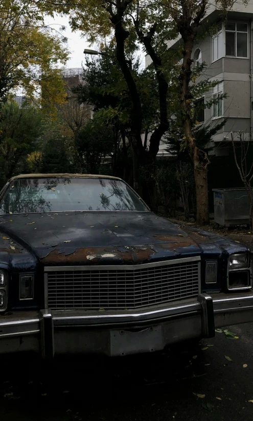 an old car parked on the side of the road