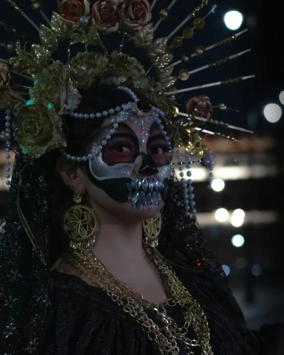 a woman with skull makeup and skeleton - painted makeup is standing