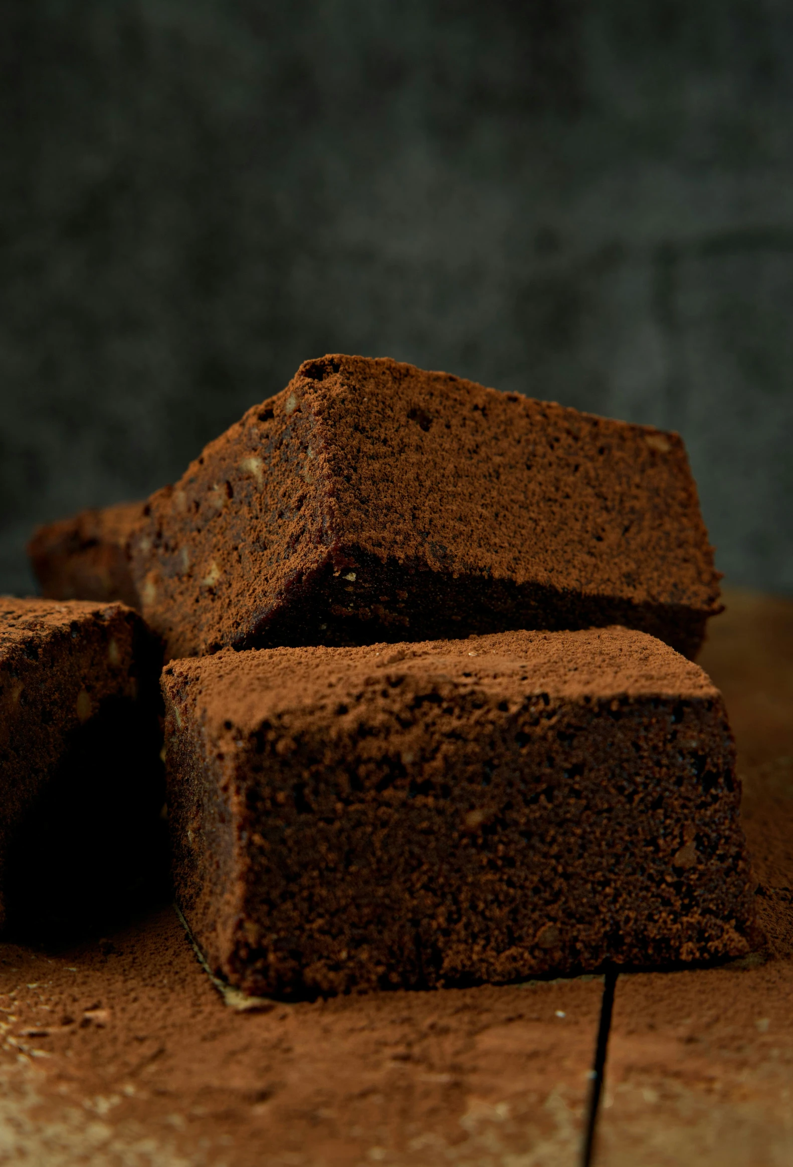 chocolate brownies stacked together on a brown table