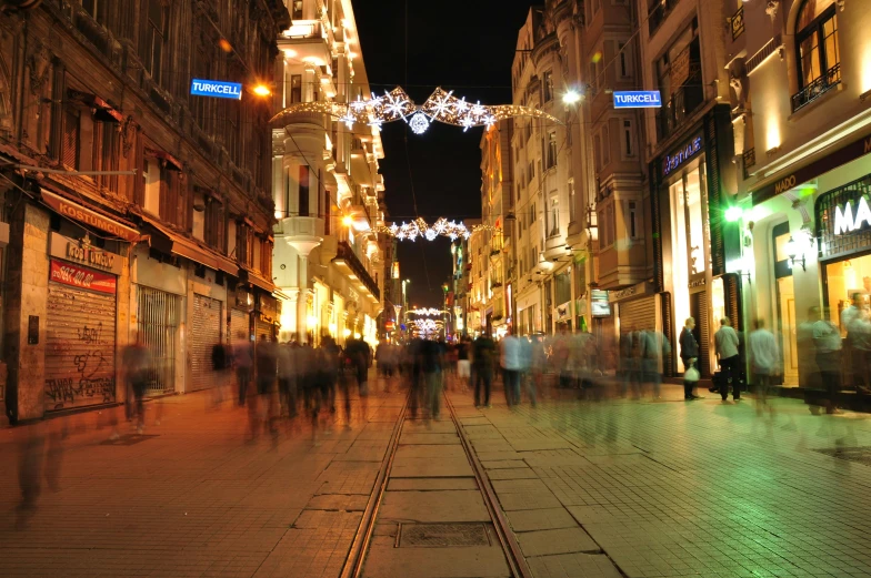 a long s of an outdoor plaza area at night with people