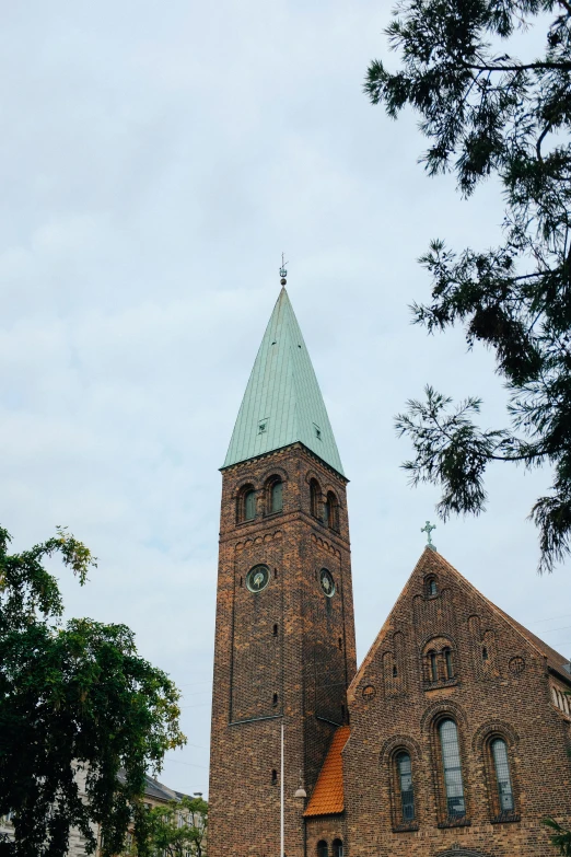 a tall brick clock tower towering over a city