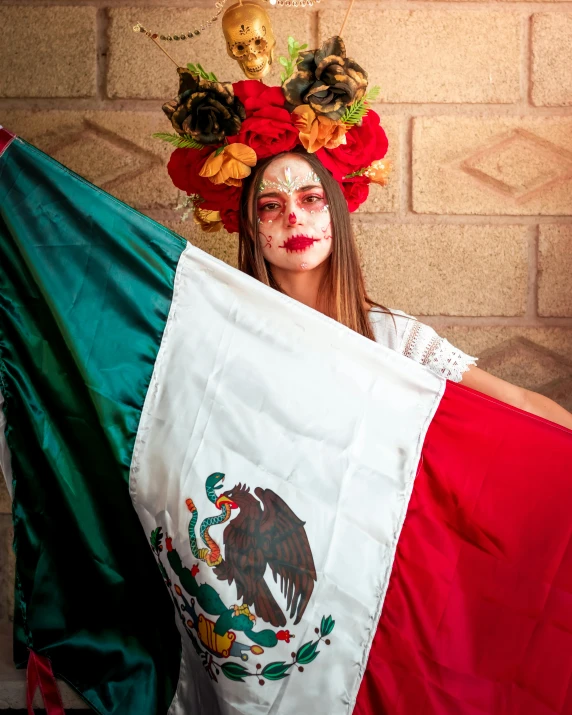 a young lady wearing a mexican gaucho costume poses with a flag