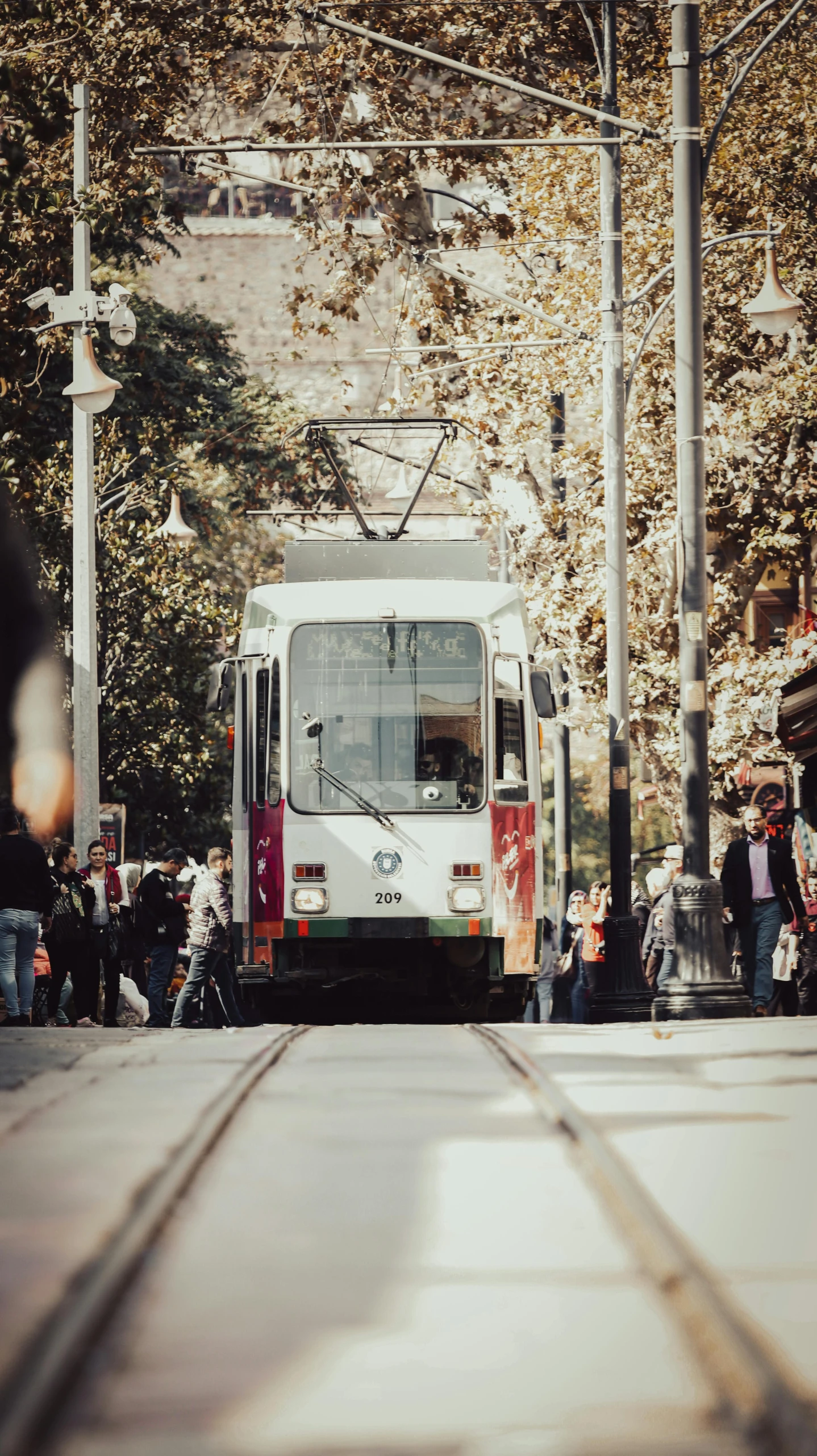 an image of a bus stop with people coming and going