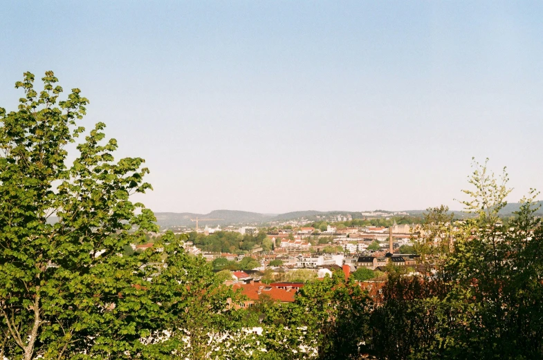 a view of the small town and mountains from above