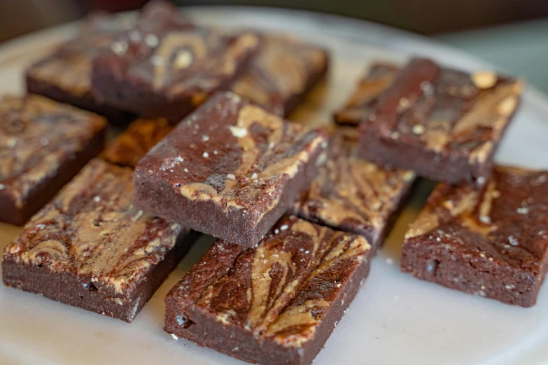 a plate of fudge brownies with nuts and pecans