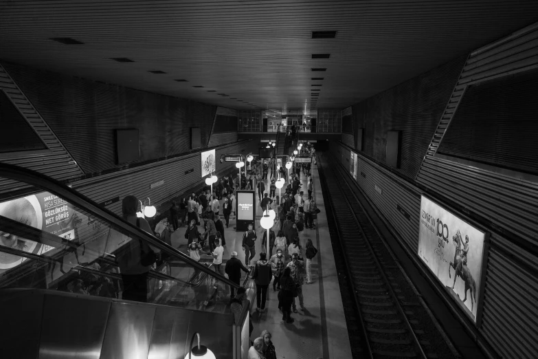 people are walking up and down an escalator