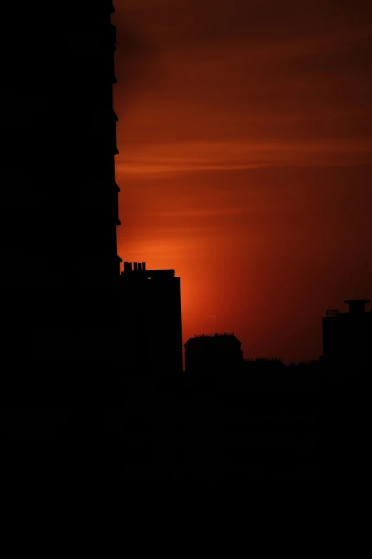 a building and the sun set in the sky