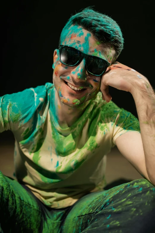 a man wearing sunglasses and paint all over his body
