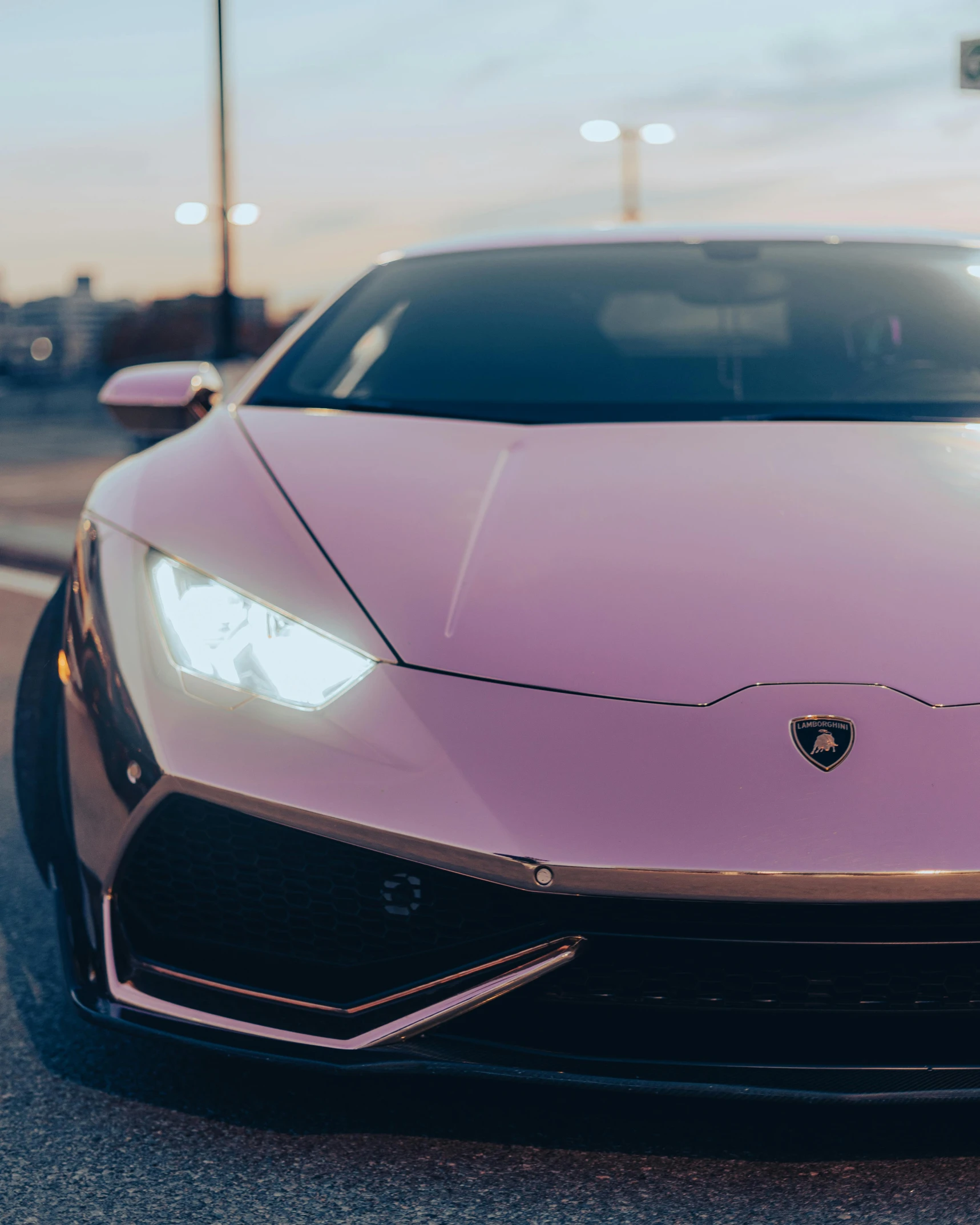 the front end of a pink lambs car parked on the side of the road