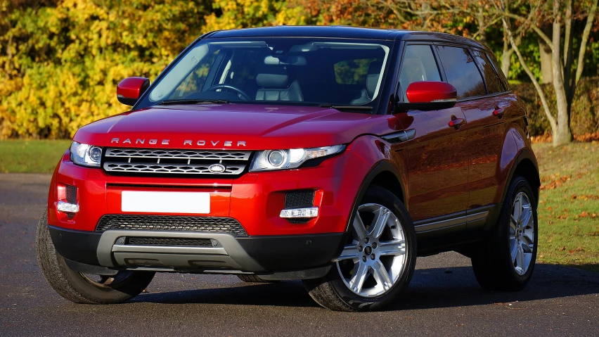 a red car is driving along a street