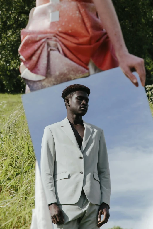 a man holding a framed picture over his head