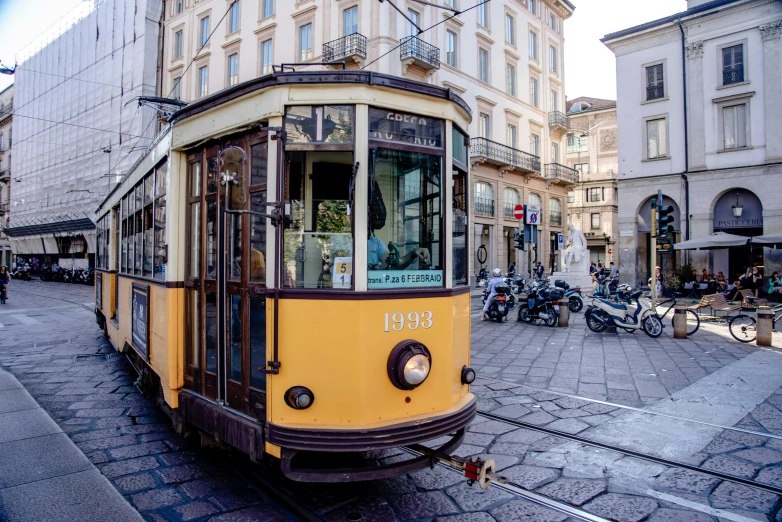 an old train is driving down the street