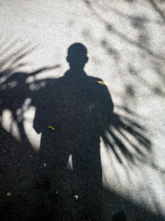 a man standing on the side of a road next to a sidewalk