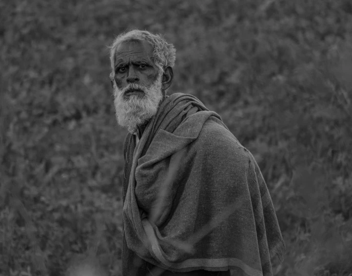 a black and white po of a man with a big beard