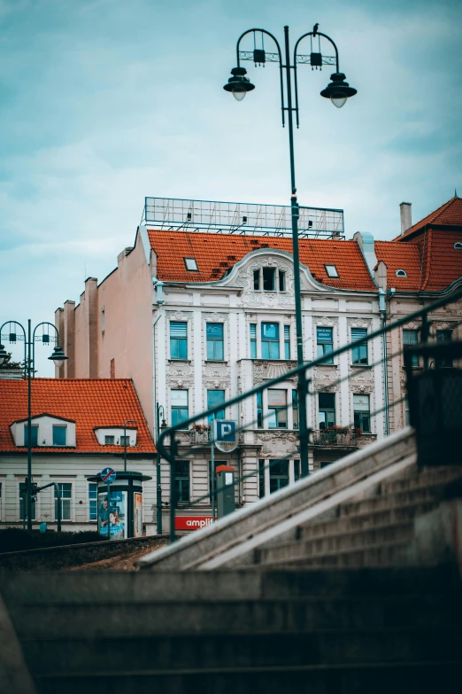 the roof tops of several buildings and two lights