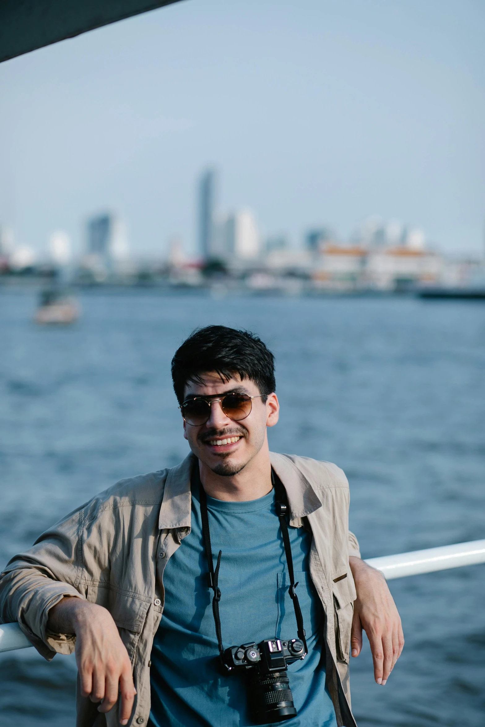 a person standing near the water and with his camera in hand