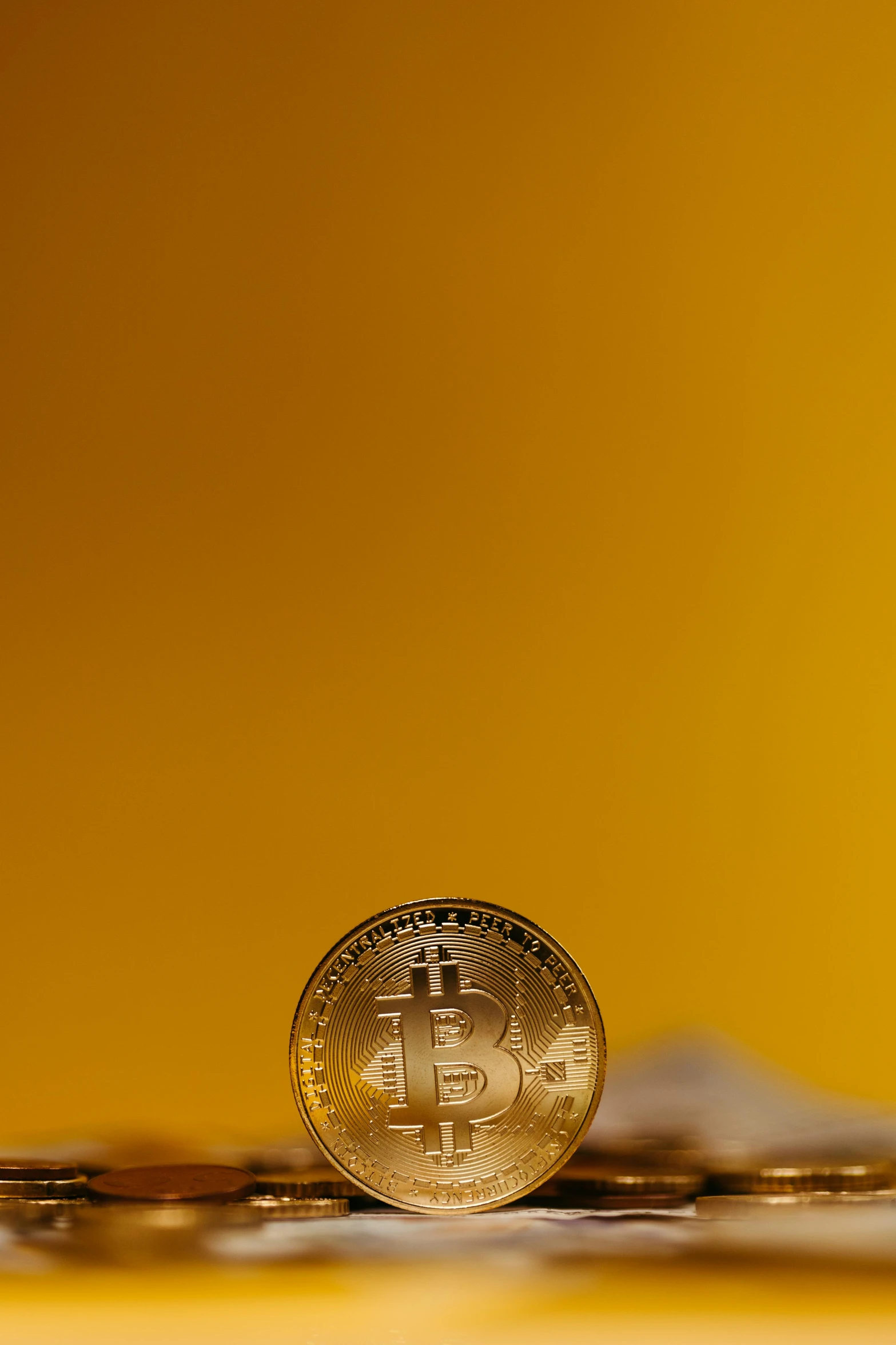 an pound coin sitting on a pile of coins