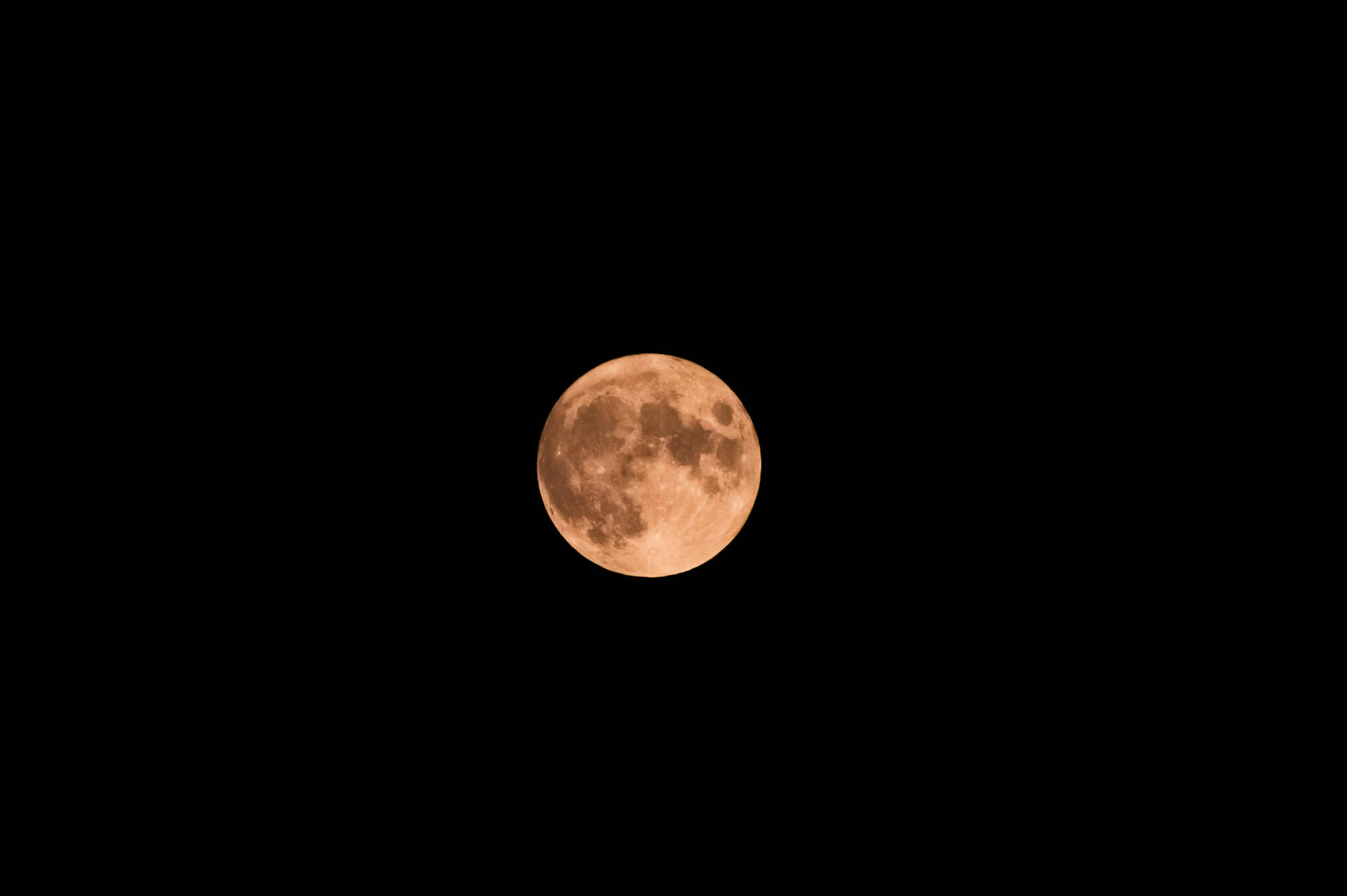 a bright red moon in a dark black sky