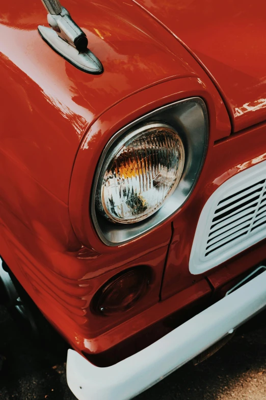 the front end of an old red car