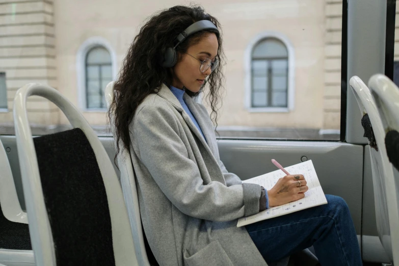 a woman is using a phone and writing on a clipboard